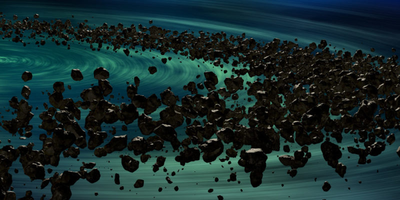 Imagen con fondo azul y rocas del espacio (Asteroides formando) formando una elipsis alrededor del Sol